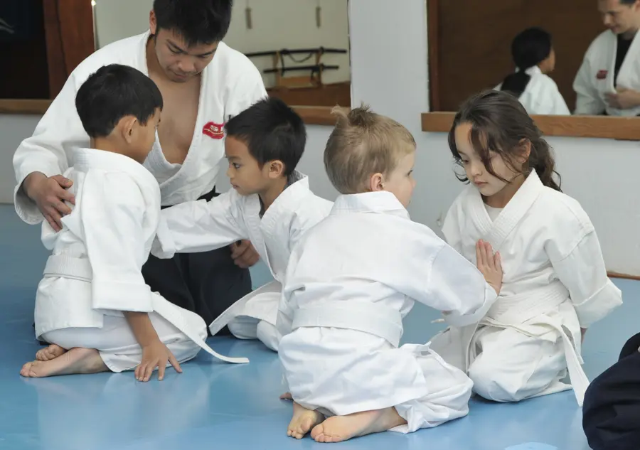 Youth Aikido students practicing together with their instructor